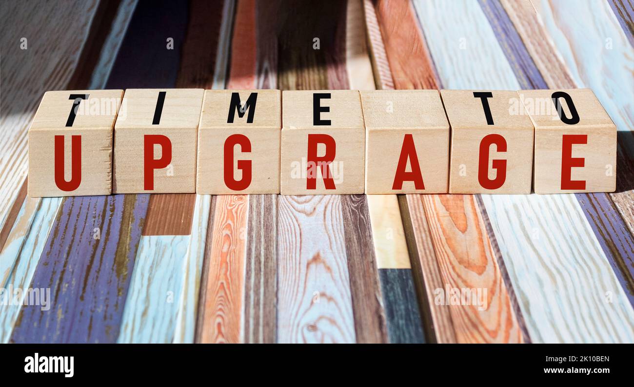 TIME TO UPGRADE written on wooden cubes and vintage background Stock Photo