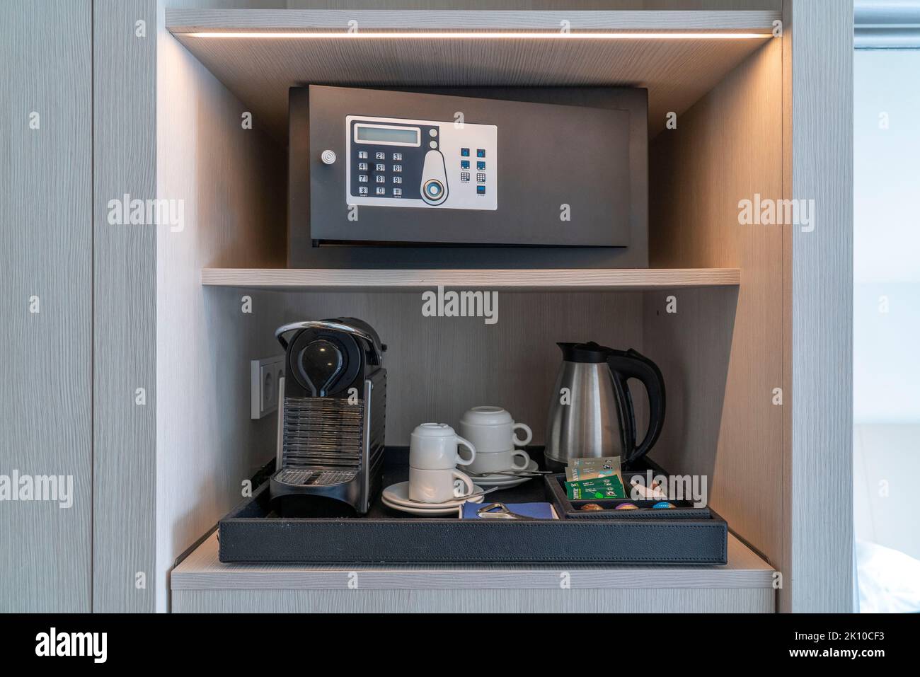 https://c8.alamy.com/comp/2K10CF3/hotel-safe-in-a-hotel-room-coffee-machine-glasses-cups-as-a-service-for-the-guest-2K10CF3.jpg