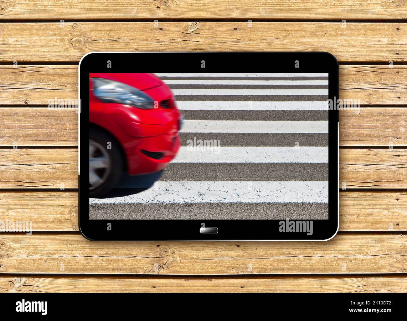 Black and white pedestrian crossing with red car on background ...