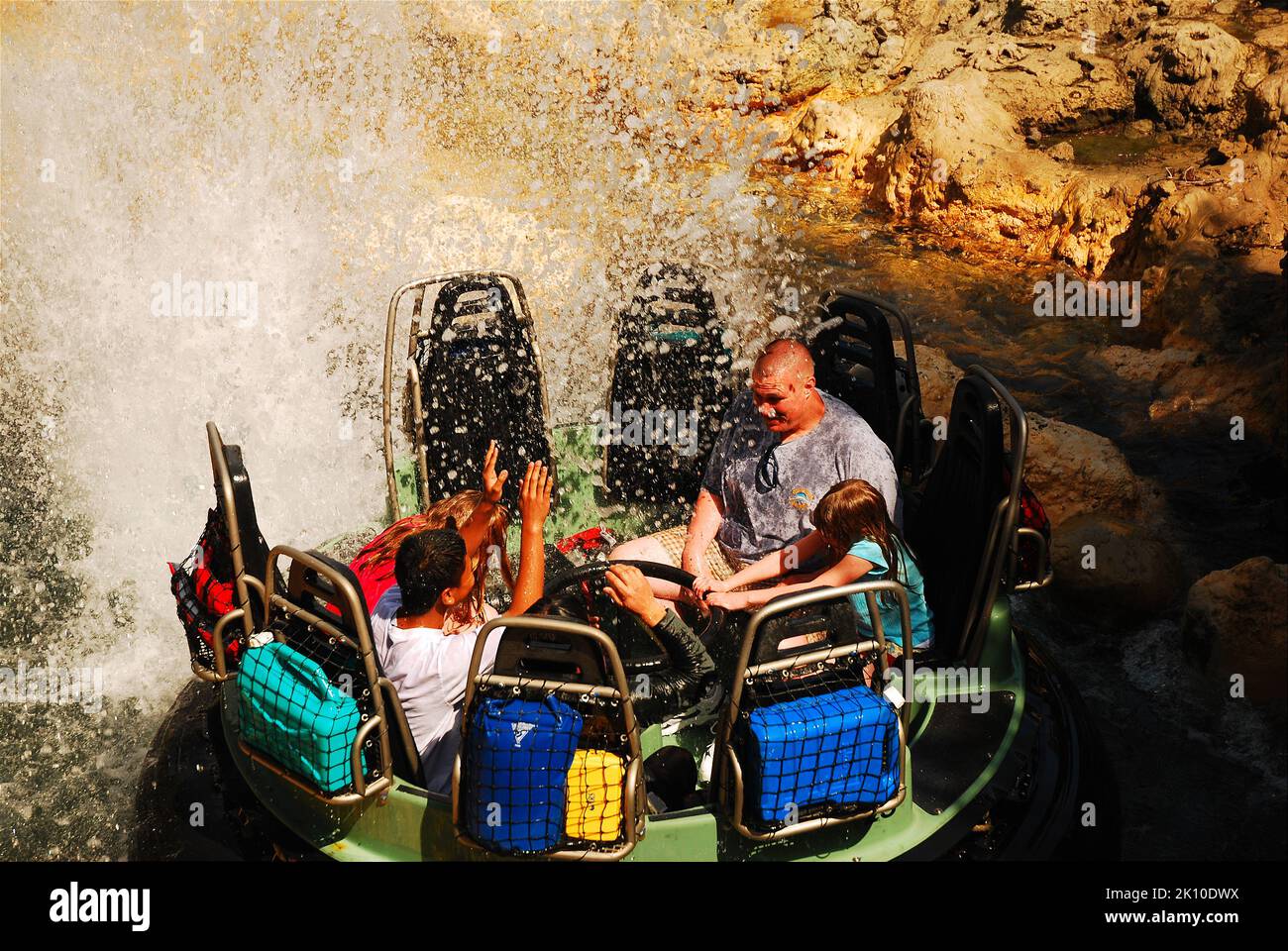 A family gets soaked and wet while riding on the Grizzly River Run, a water ride in Disneyland's California Adventure amusement park Stock Photo