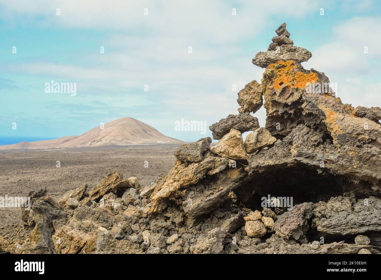 Volcanic stones pointing the way through the lava Stock Photo