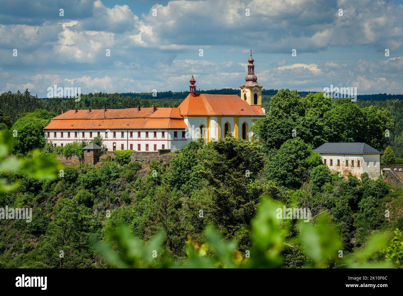 Rabstejn nad Strelou, Czech Republic - June 12 2022: View of the building of former monastery of Servites and the Virgin Mary church standing on a roc Stock Photo