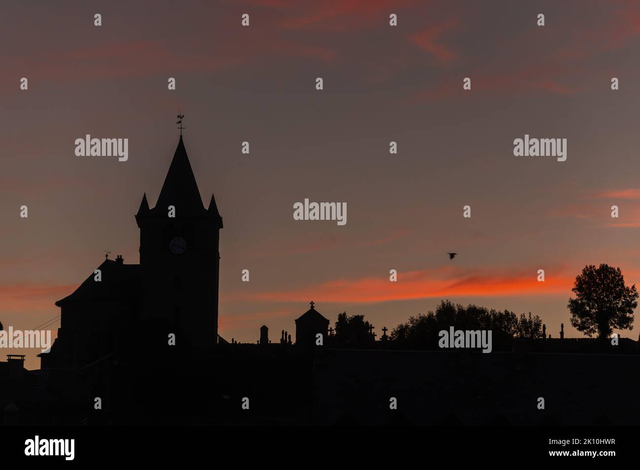 Silhouette of church of St Mathieu in Laguiole at sunset. Laguiole ...