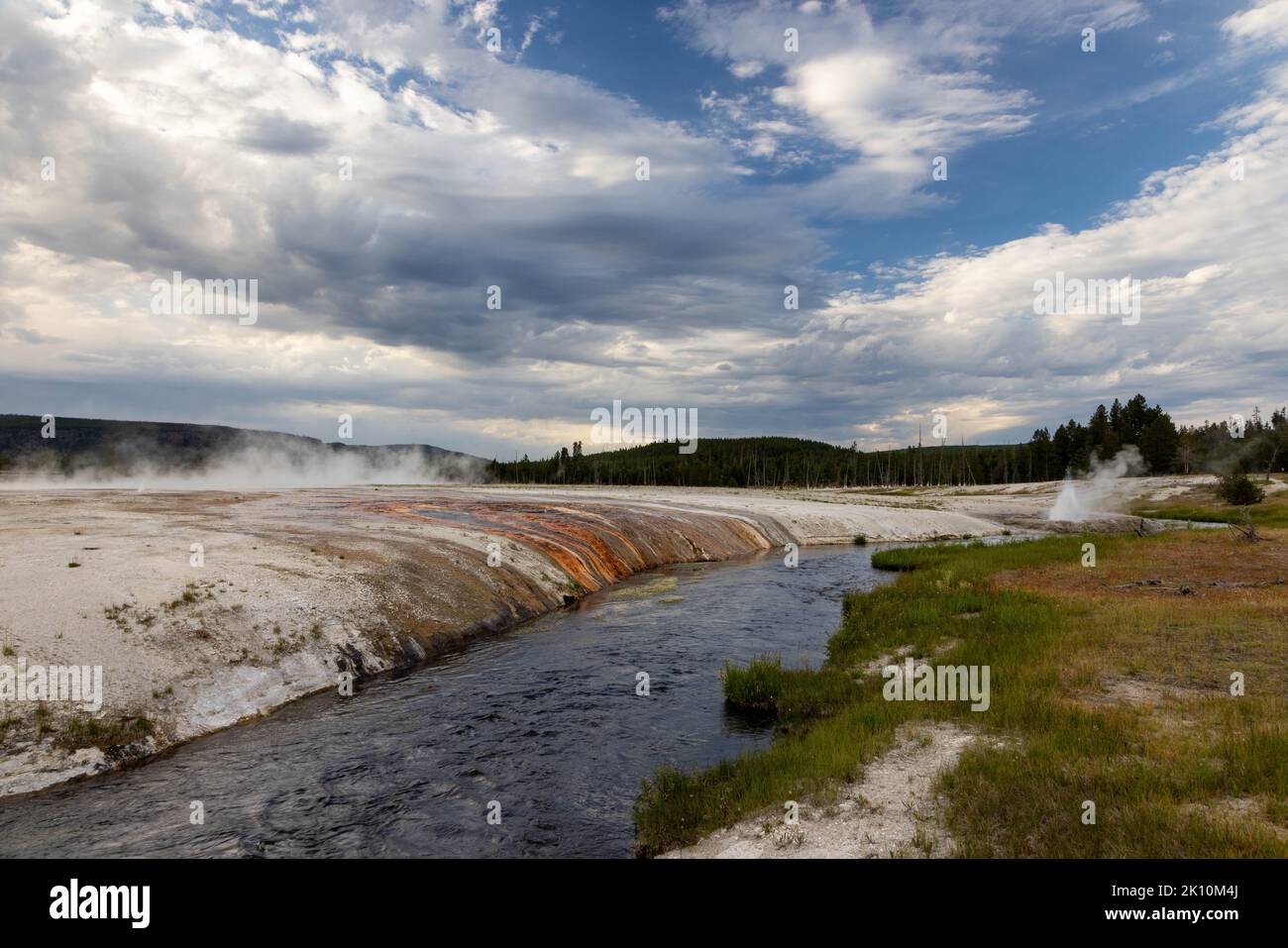 Iron Spring Creek flowing past runoff from Rainbow Pool and Cliff Geyser in the Black Sand Basin. Yellowstone National Park, Wyoming Stock Photo