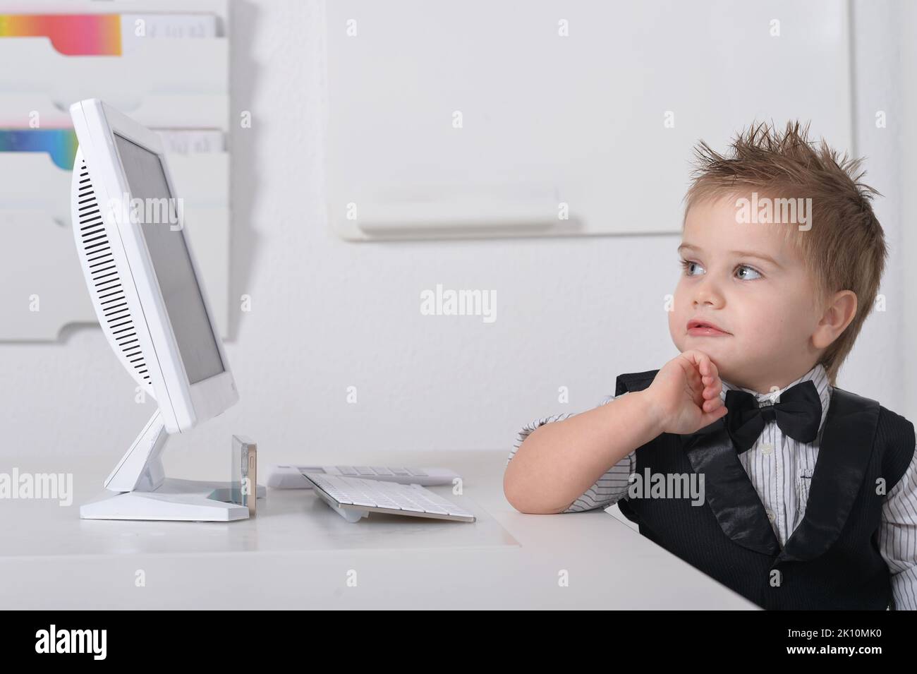 little-handsome-boy-sits-with-a-computer-stock-photo-alamy