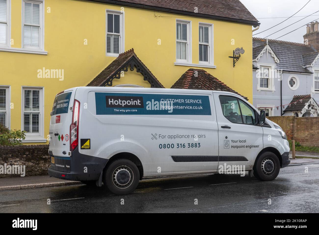 Hotpoint engineer van park outside a house in Hampshire, England, UK Stock Photo