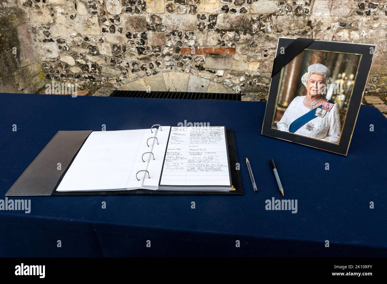 A book of condolences beside a photograph of Queens Elizabeth II following the Queens death, Winchester, Hampshire, England, UK, September 2022 Stock Photo