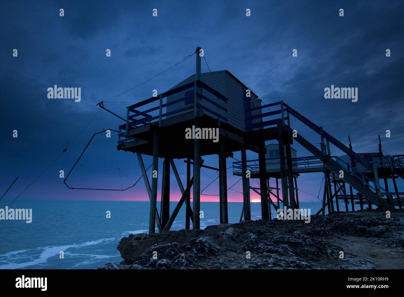 Sunset with a dark sky on the French Atlantic coast flounder fishing