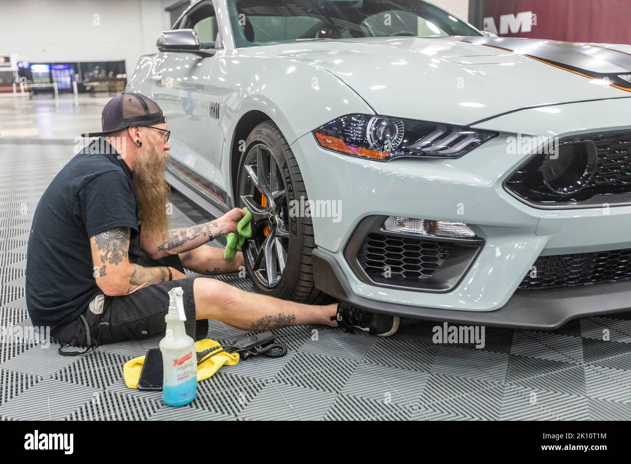 Detroit, Michigan, USA. 14th Sep, 2022. A worker polishes the wheel of a Ford Mustang Mach 1 at the North American International Auto Show. Credit: Jim West/Alamy Live News Stock Photo