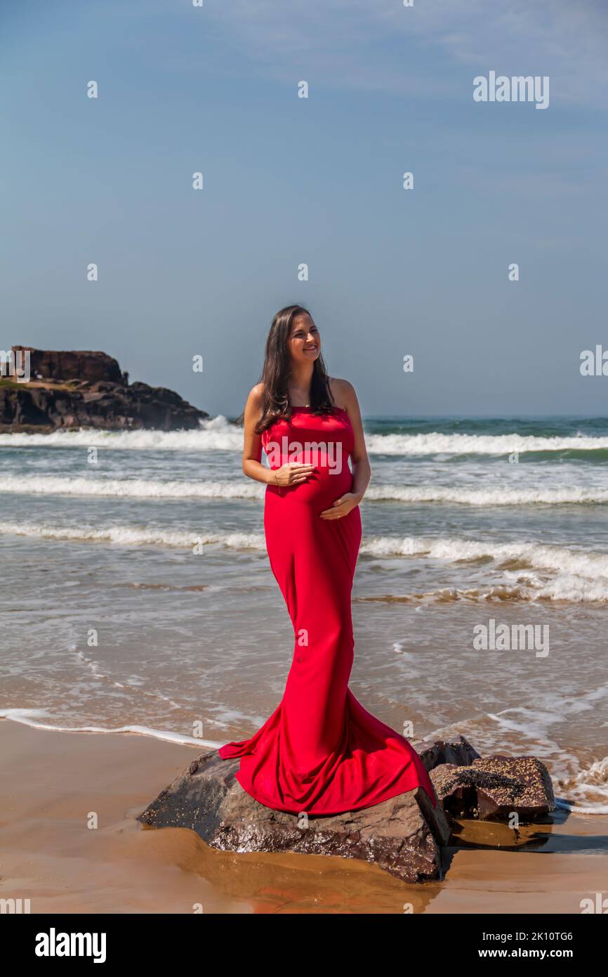 Pregnant woman in red dress hi-res stock photography and images - Alamy