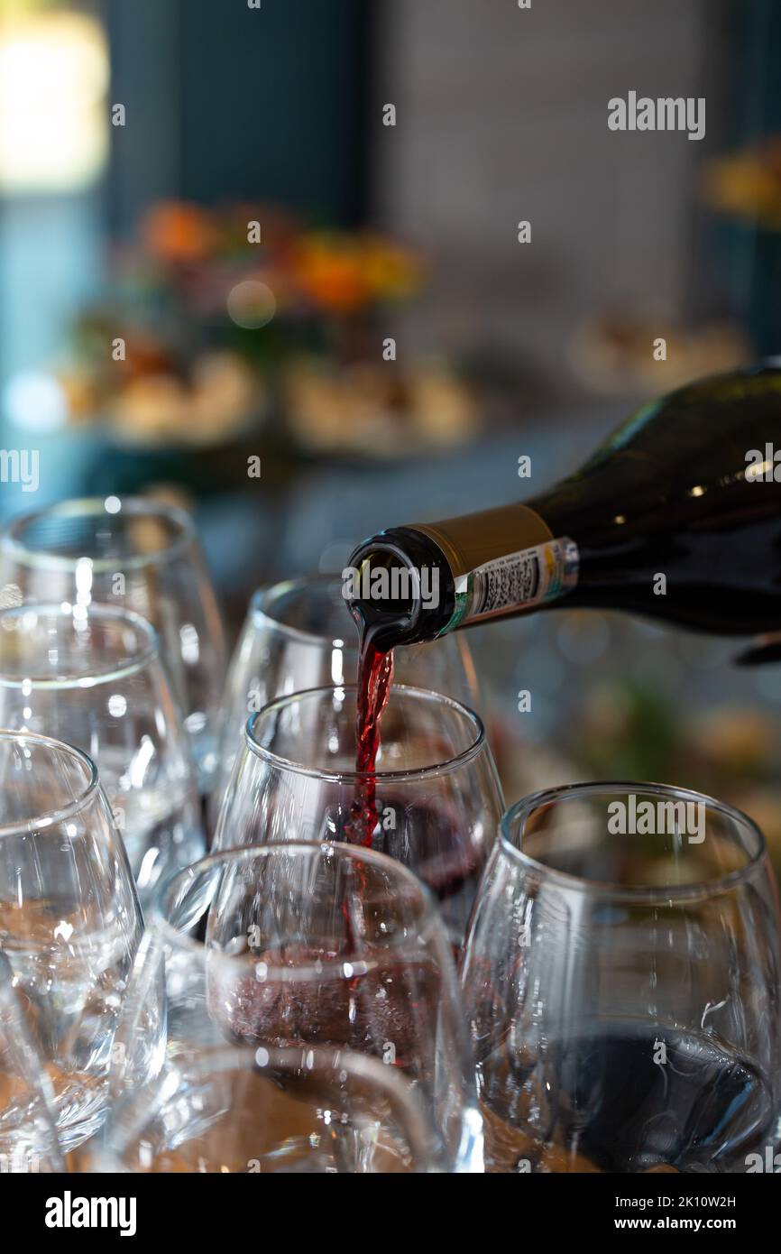 bottling red wine from a bottle by glasses closeup Stock Photo Alamy