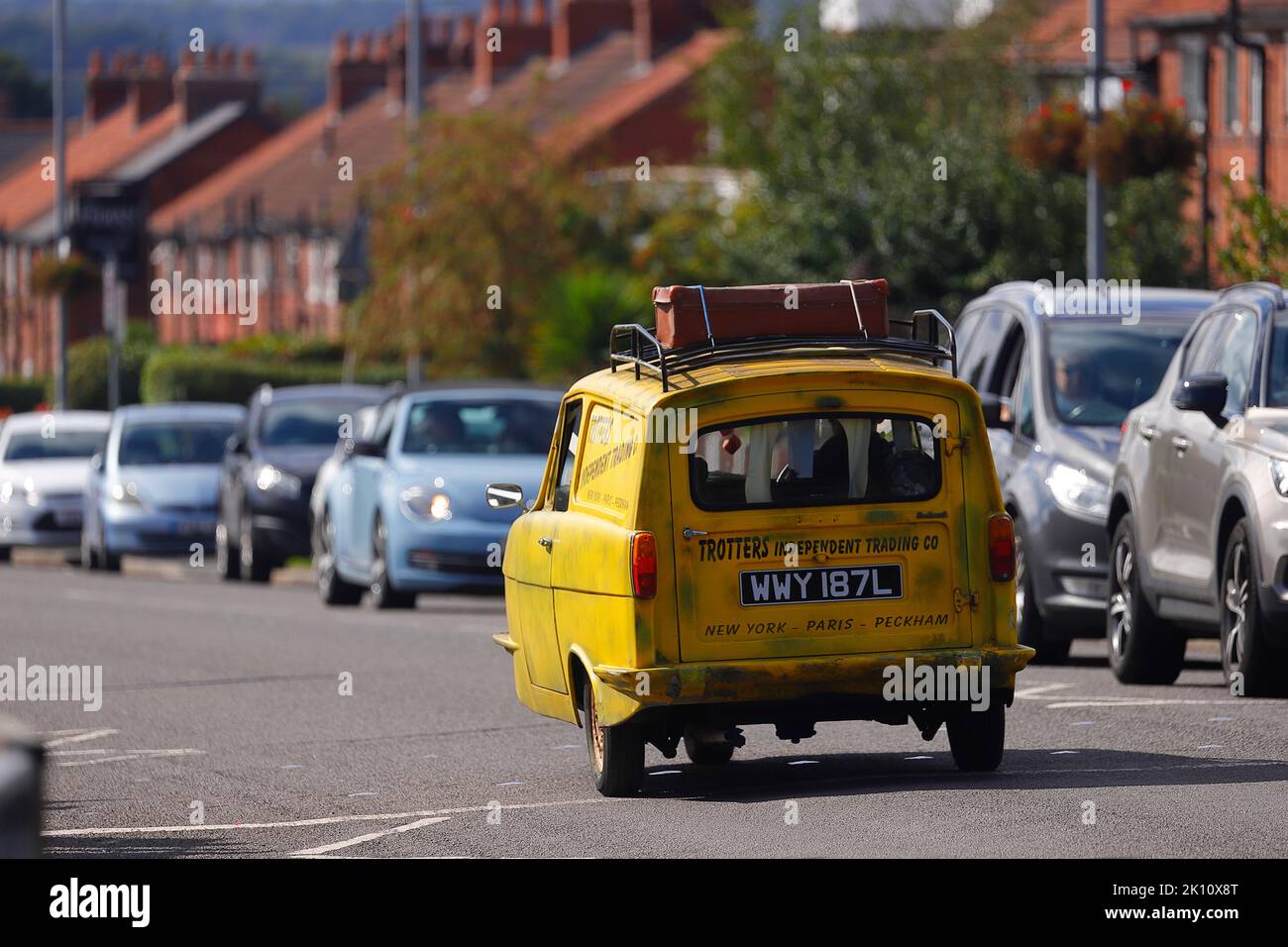 A replica of Trotters yellow Reliant Robin from the TV sitcom 'Only Fools & Horses' seen used as a wedding car in Swillington,Leeds,UK Stock Photo