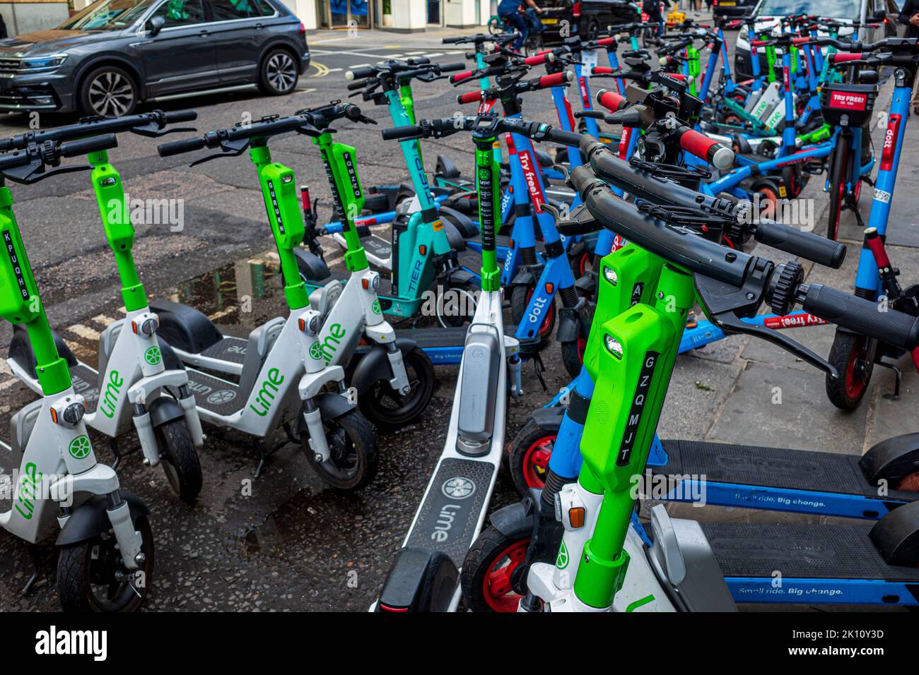 E-Scooter Congestion London - E-Scooters London - E-Scooters parked in designated space in Central London. Approved E-Scooters for hire in London. Stock Photo