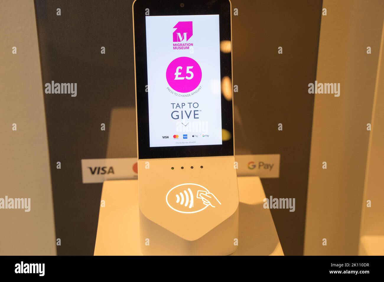contactless payment terminal accepting donations from visitors to migration museum in Lewisham UK Stock Photo