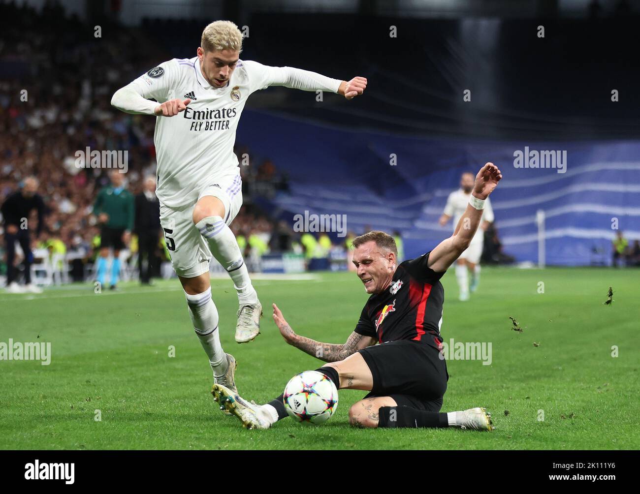 Madrid, Germany. 14th Sep, 2022. Soccer: Champions League, Group Stage, Group F, Matchday 2 Real Madrid - RB Leipzig at Santiago Bernabeu Stadium. Leipzig's David Raum (r) and Madrid's Federico Valverde fight for the ball. Credit: Jan Woitas/dpa/Alamy Live News Stock Photo