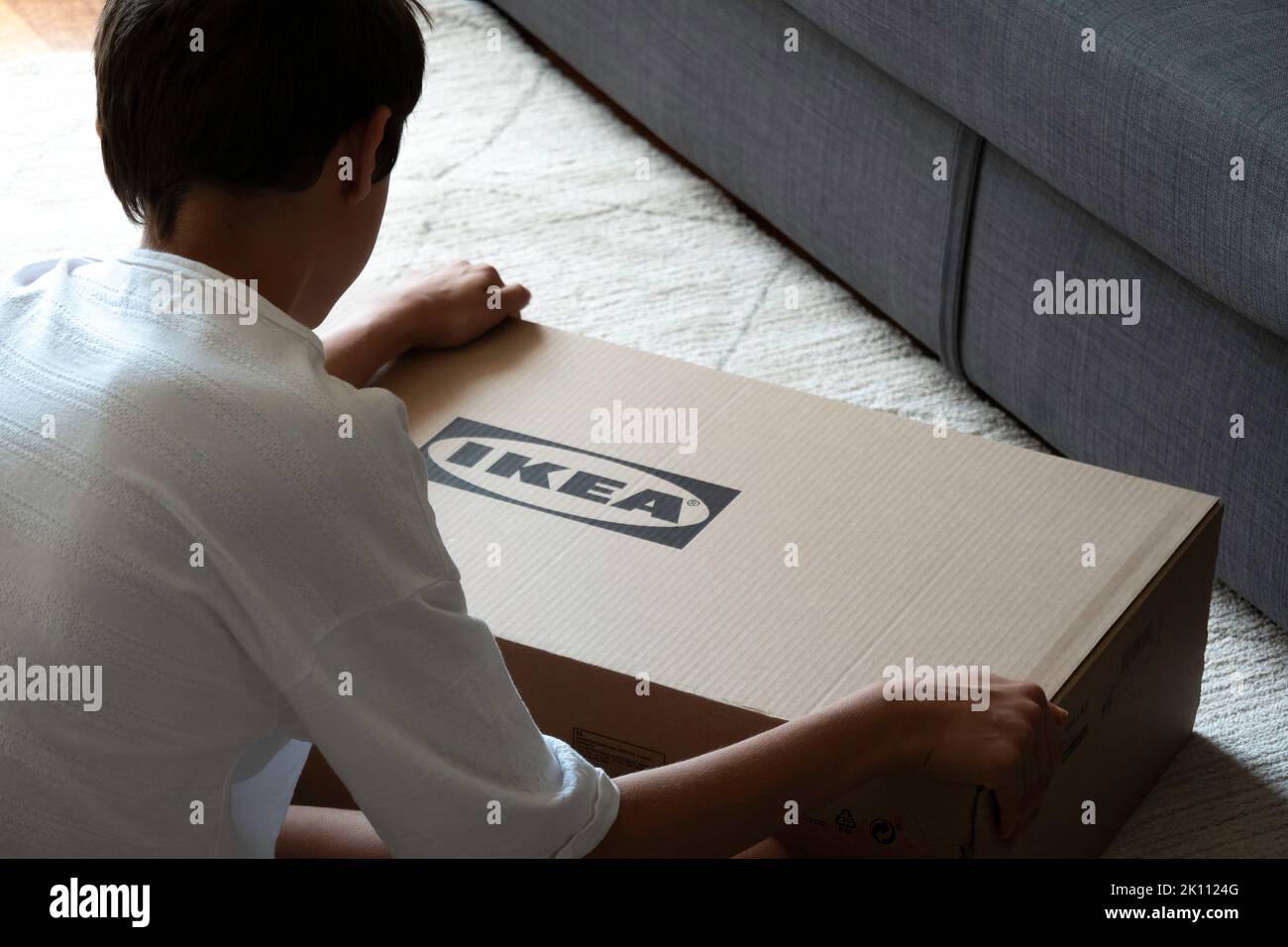 Vilnius, Lithuania July 7, 2022 Teenage boy assemble Ikea furniture