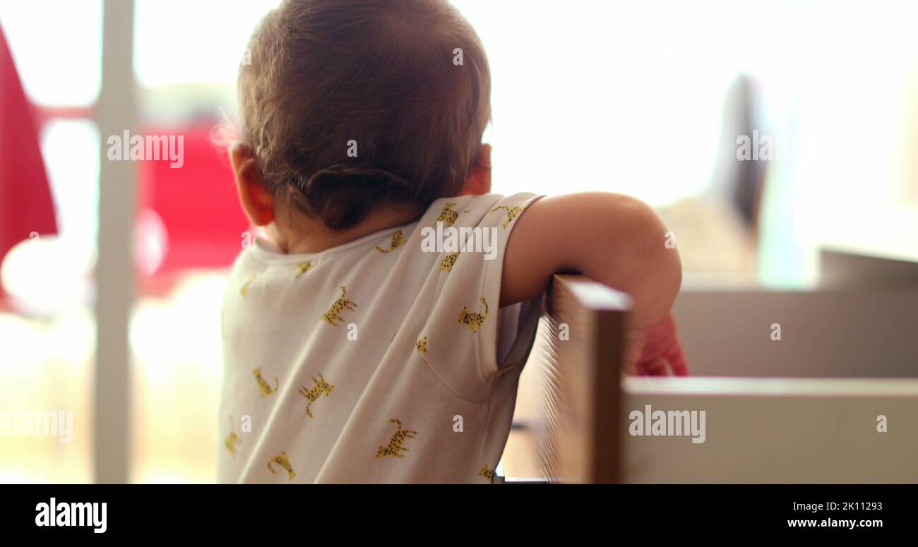 Baby grabbing something from drawer Stock Photo Alamy