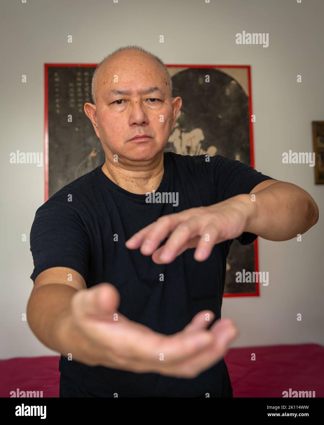 A senior man practicing martial arts indoor. Stock Photo