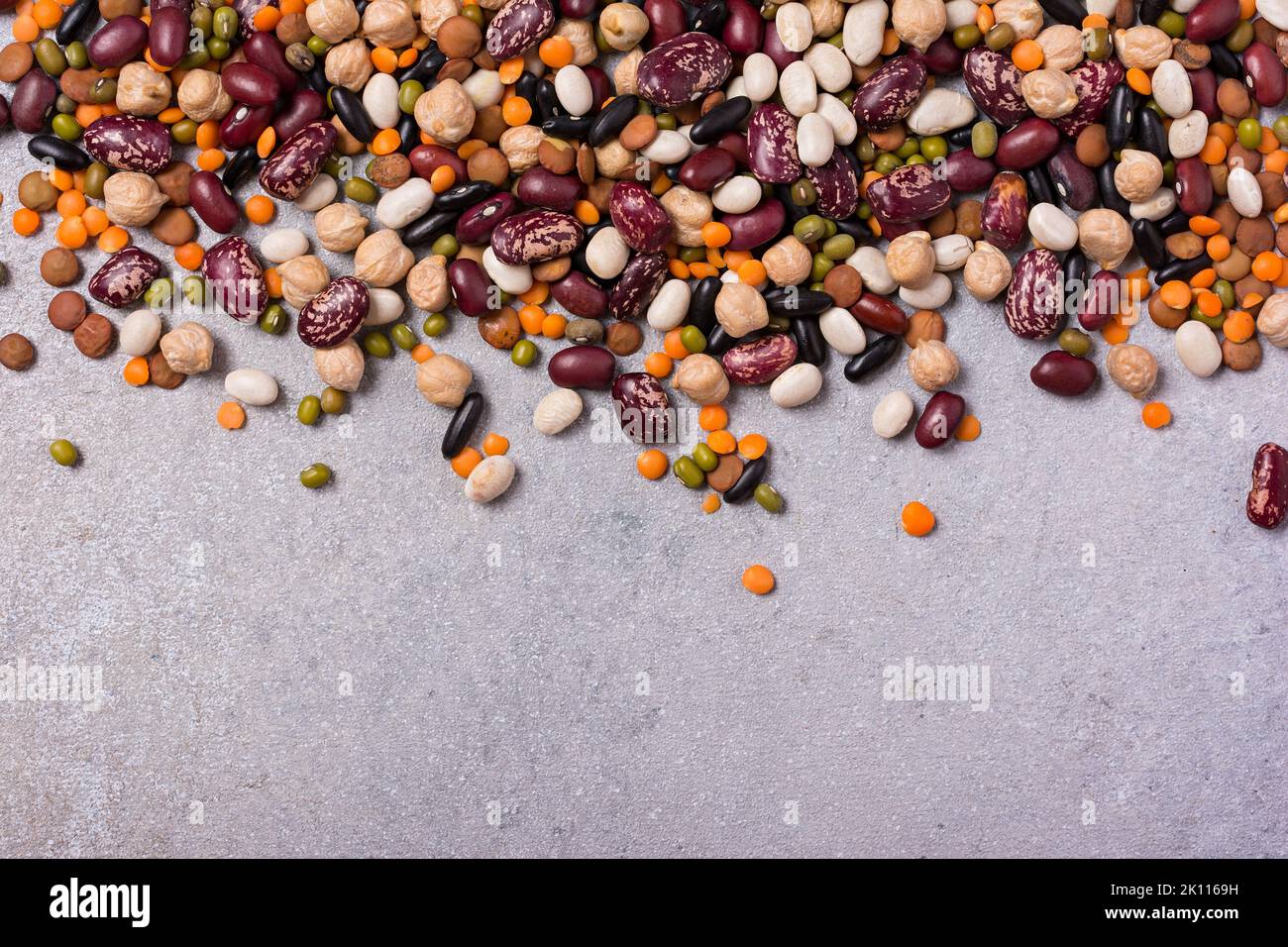 Top view of different beans, lentils, mung or maash and chickpeas on grey concrete background Stock Photo