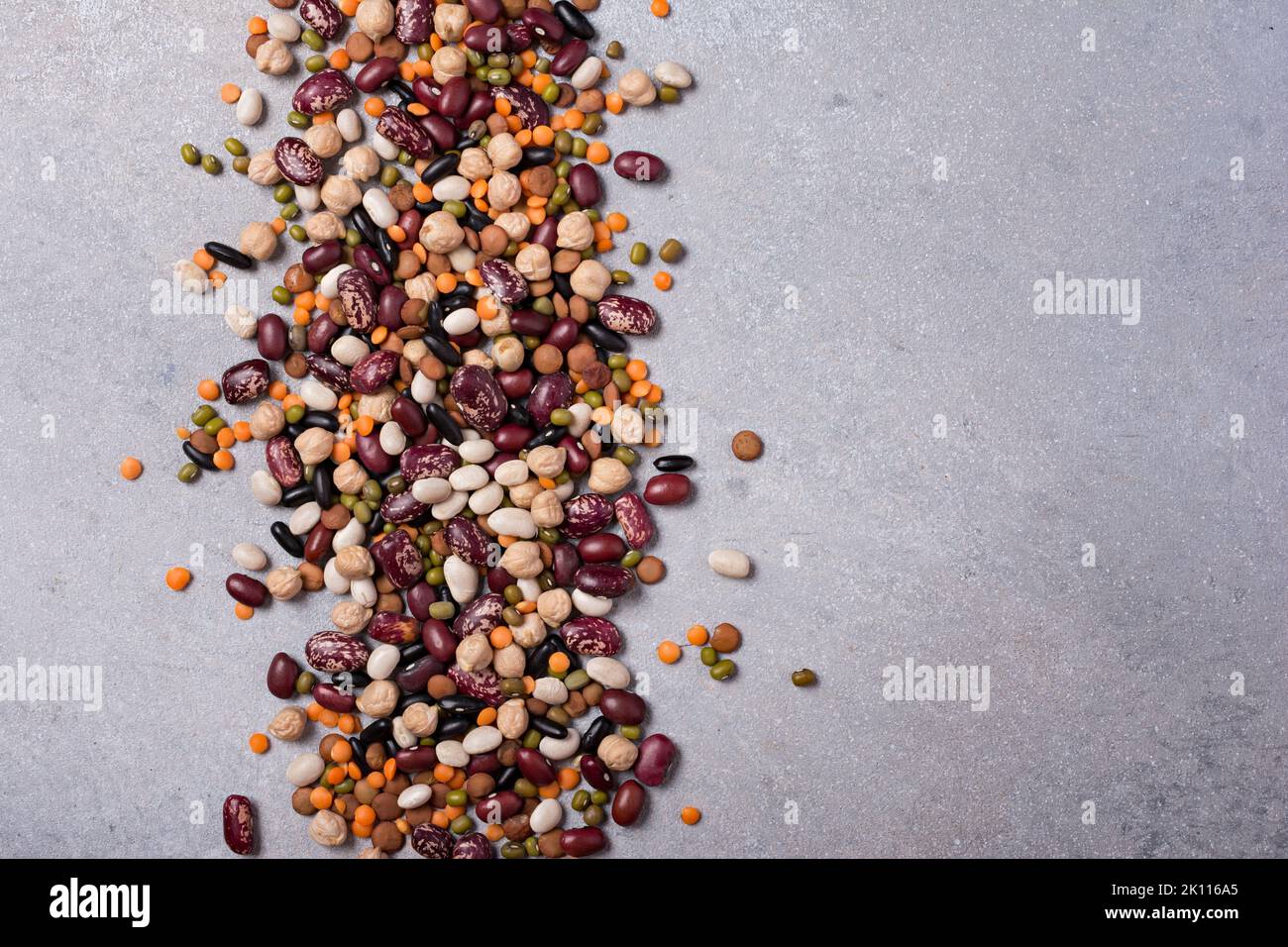 Top view of different beans, lentils, mung or maash and chickpeas on grey concrete background Stock Photo