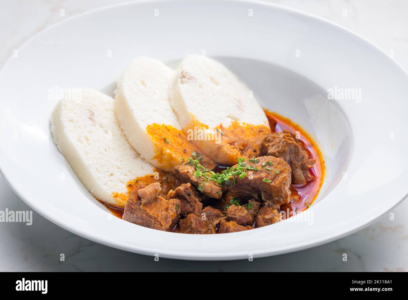 beef goulash served with dumplings Stock Photo