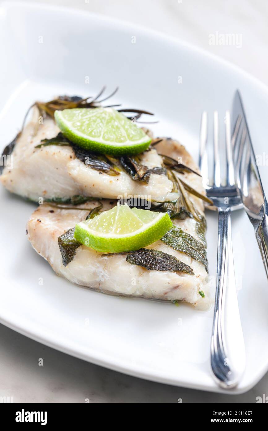 white fish fillet baked with herbs Stock Photo - Alamy