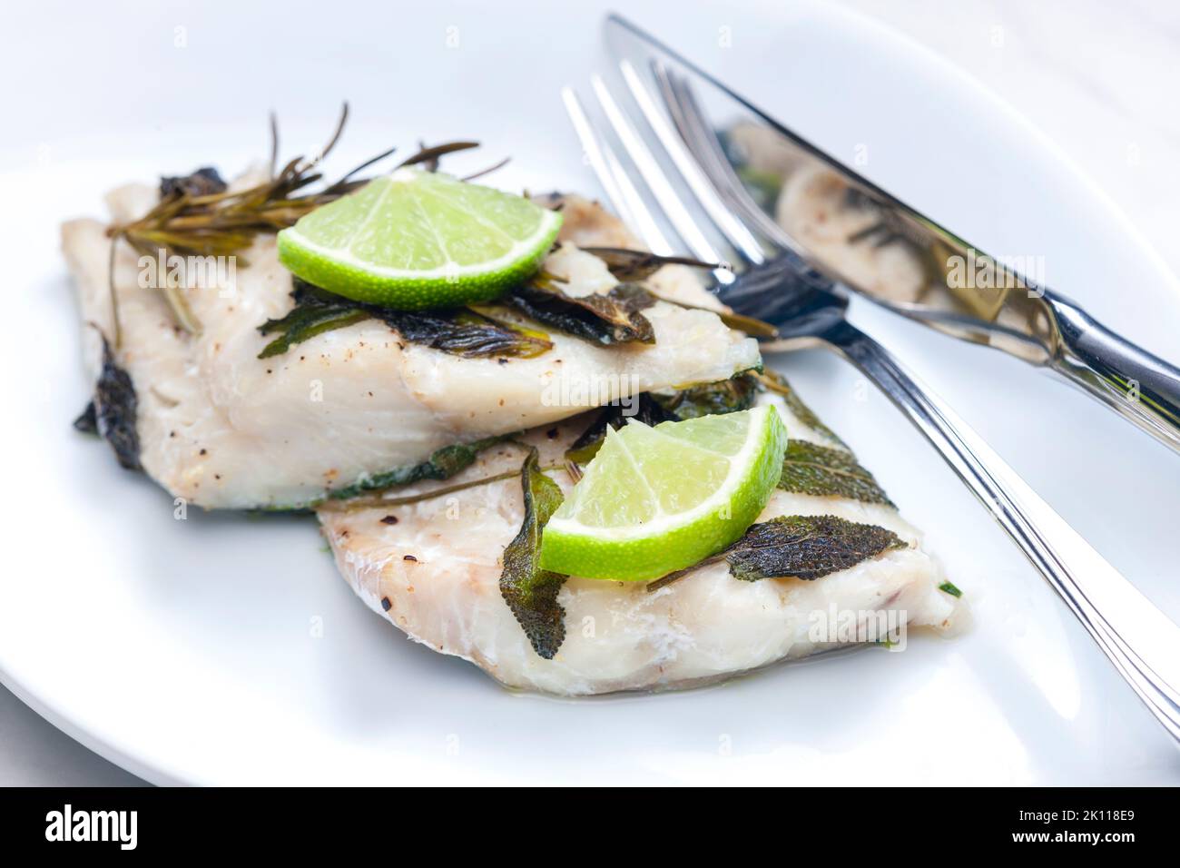white fish fillet baked with herbs Stock Photo - Alamy