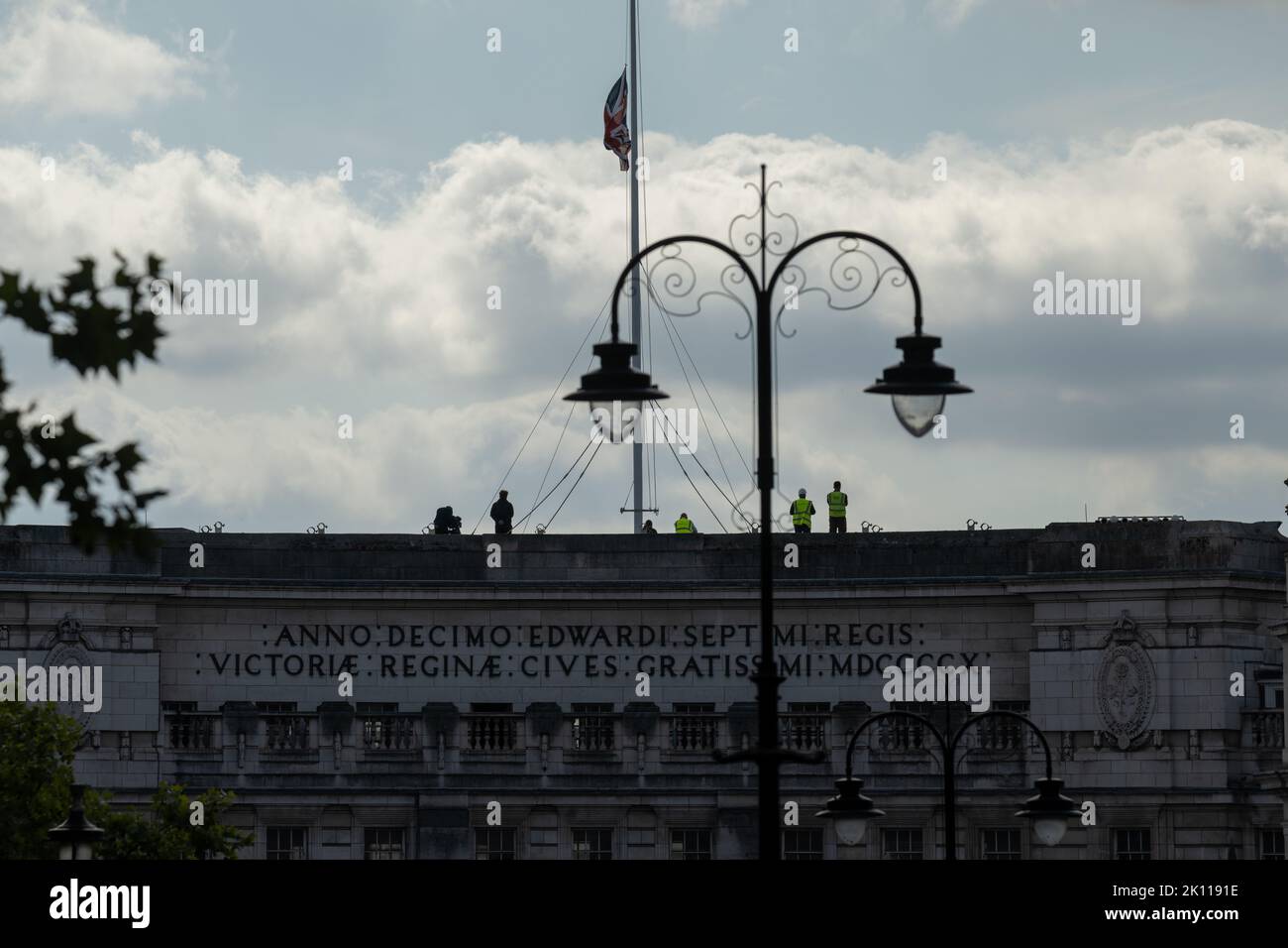London, UK. 14th Sep, 2022. Vast crowds gathered around Trafalgar Square and surrounds in a vain attempt to see the procession of the coffin of HM The Queen Spectators on the top of Admiralty Arch with the flag at half mast Credit: Ian Davidson/Alamy Live News Stock Photo