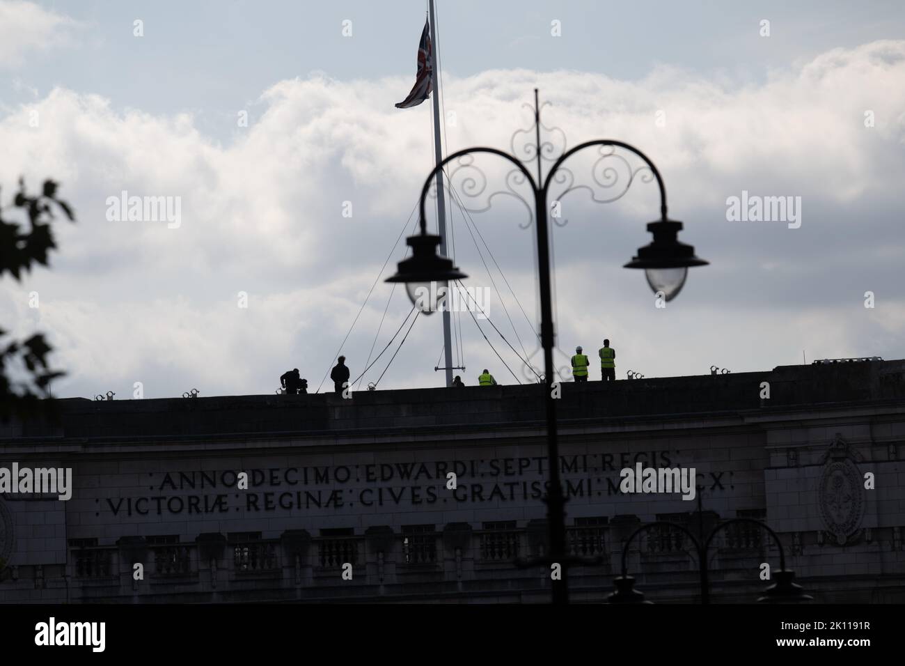 London, UK. 14th Sep, 2022. Vast crowds gathered around Trafalgar Square and surrounds in a vain attempt to see the procession of the coffin of HM The Queen spectators on top of Admiralty Arch with flag at half mast Credit: Ian Davidson/Alamy Live News Stock Photo