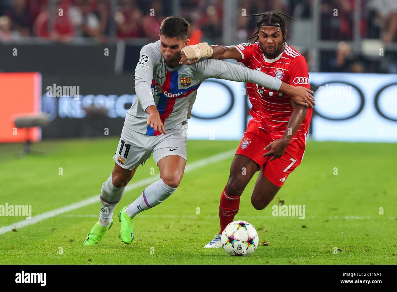 Ferran Torres of FC Barcelona in action with Gnabry of FC Bayern Munich during the UEFA Champions League match between FC Bayern Munich v FC Barcelona at Allianz Arena in Munich, Spain. Stock Photo