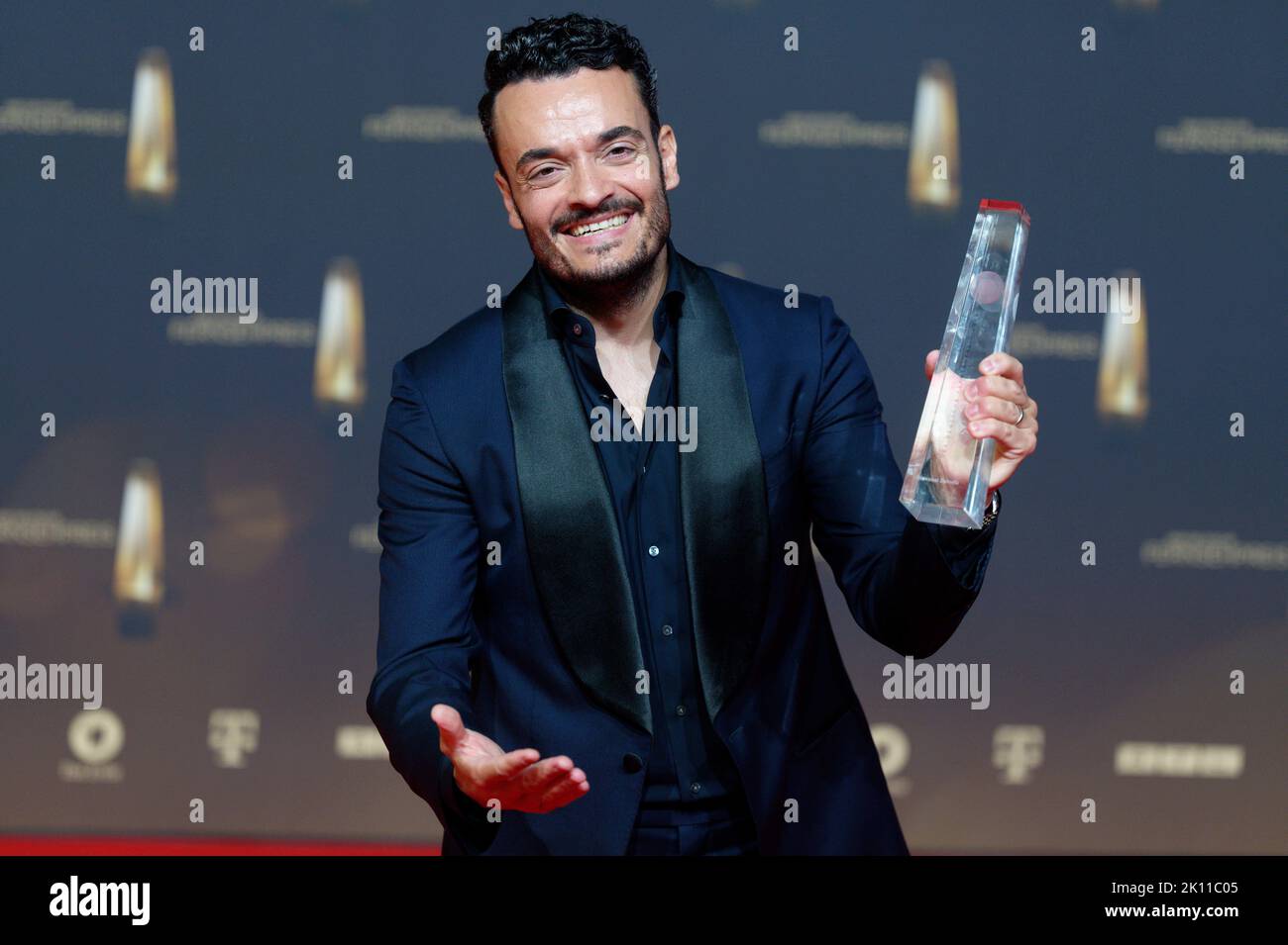 Cologne, Germany. 14th Sep, 2022. Presenter Giovanni Zarrella stands in front of a photo wall after receiving the award in the category 'Best Individual Performance/Moderation Entertainment' for 'The Giovanni Zarrella Show' at the German Television Awards 2022. Credit: Henning Kaiser/dpa/Alamy Live News Stock Photo