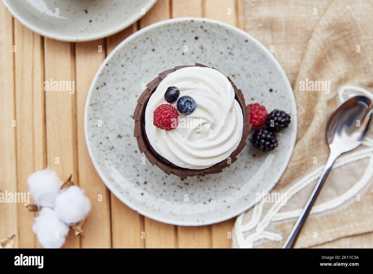 Vegeterian gluten and sugar free french cupcake close up. Atmospheric cotton decoration. Cozy lunch at the terrace. Stock Photo