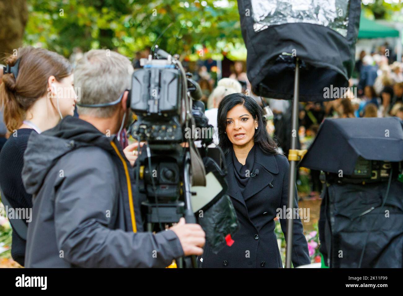 London, UK. 14th Sep, 2022. As crowds of people came to London to watch Her Majesty the Queen's coffin being transported to the Palace of Westminster, a foreign tv news crew are pictured as they do a live broadcast in Green Park, London. Credit: Lynchpics/Alamy Live News Stock Photo