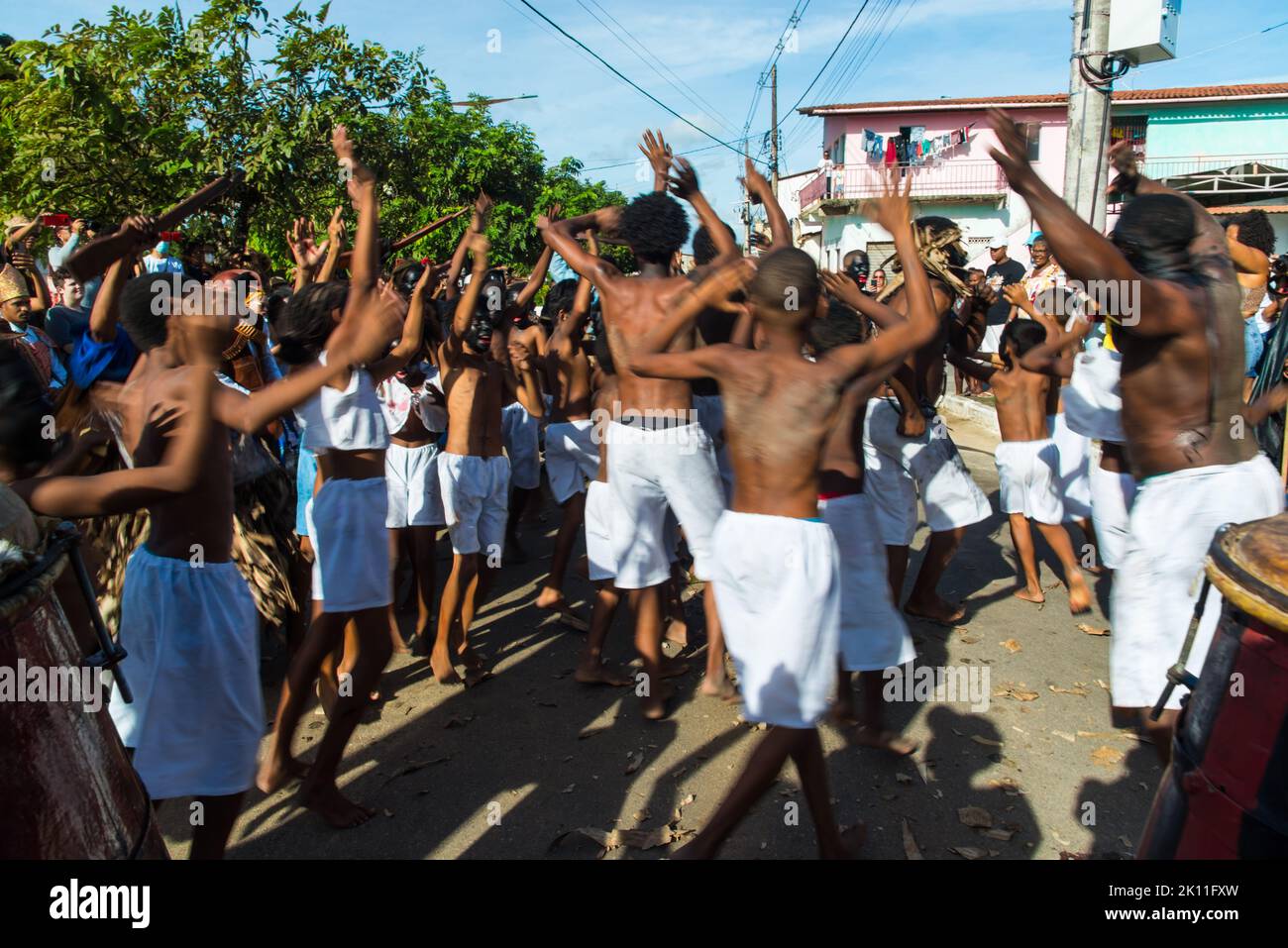 Members of the cultural event Nego Fugido sing and sit on the ground ...