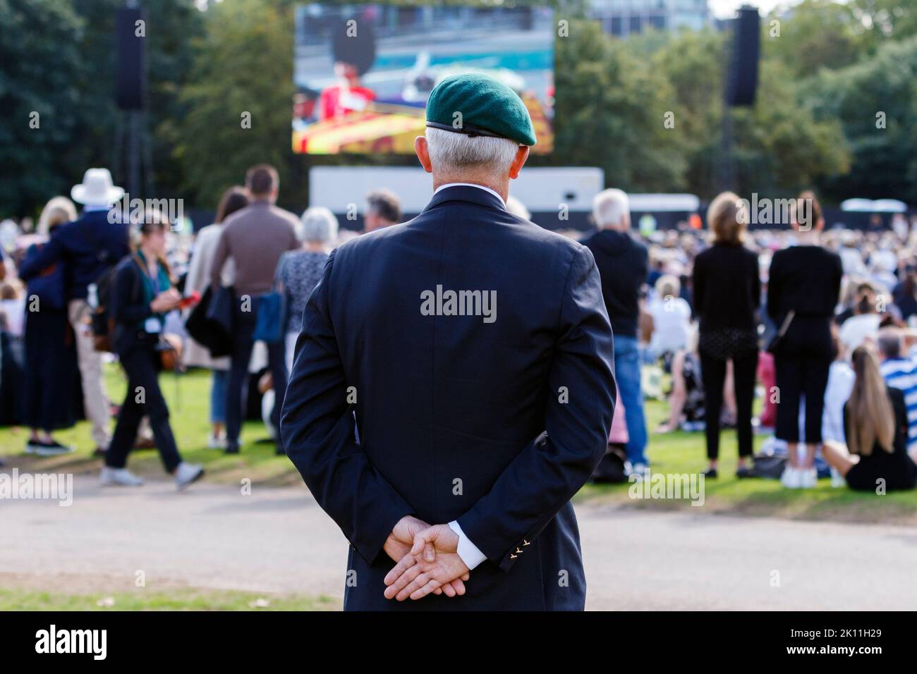 London, UK. 14th Sep, 2022. As crowds of people came to London to watch Her Majesty the Queen's coffin being transported to the Palace of Westminster, an ex serviceman is pictured watching the event on large video screens in Hyde Park, London. Credit: Lynchpics/Alamy Live News Stock Photo