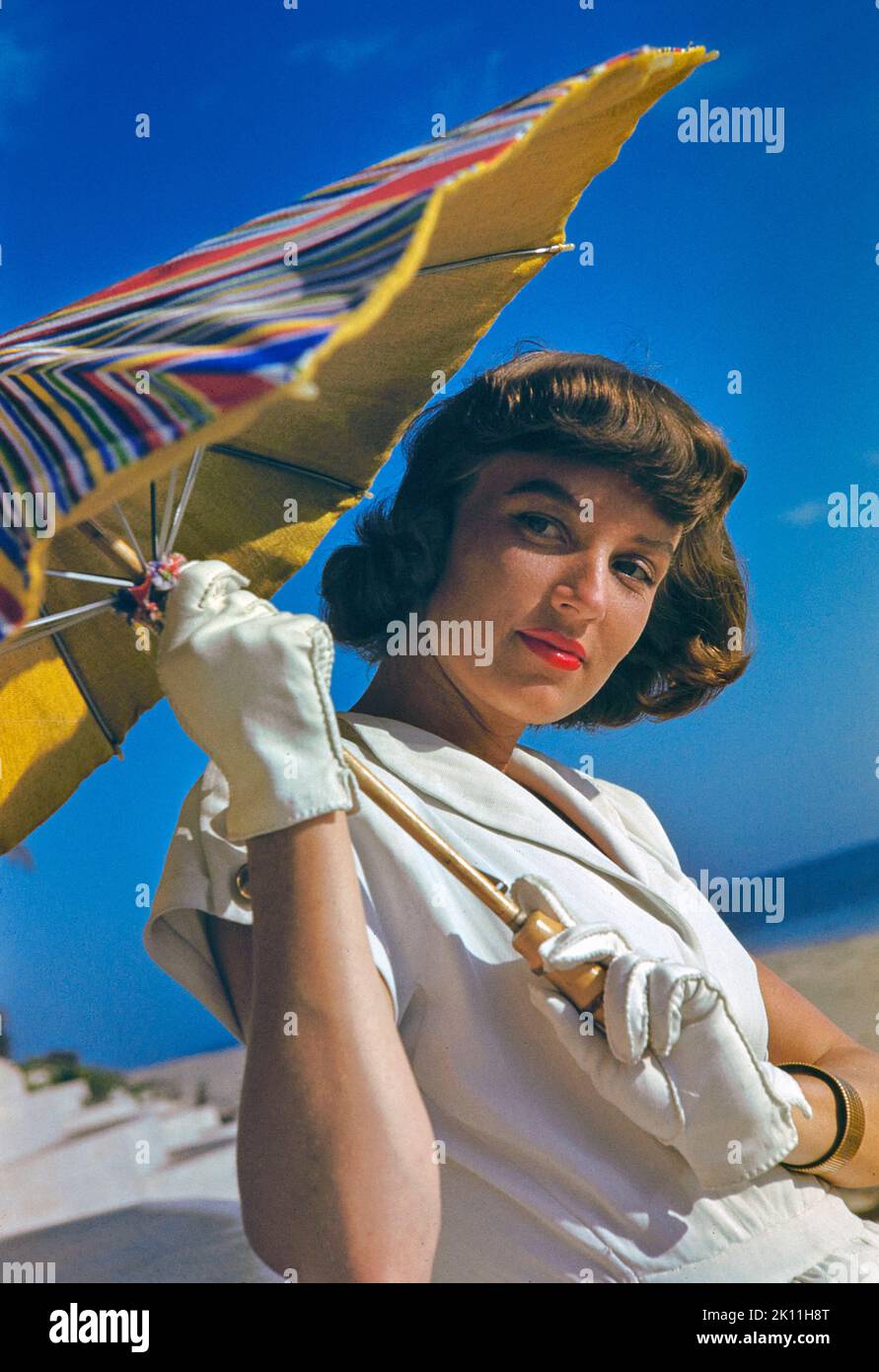 Young Adult Woman in White Dress with Sun Umbrella, Toni Frissell Collection Stock Photo