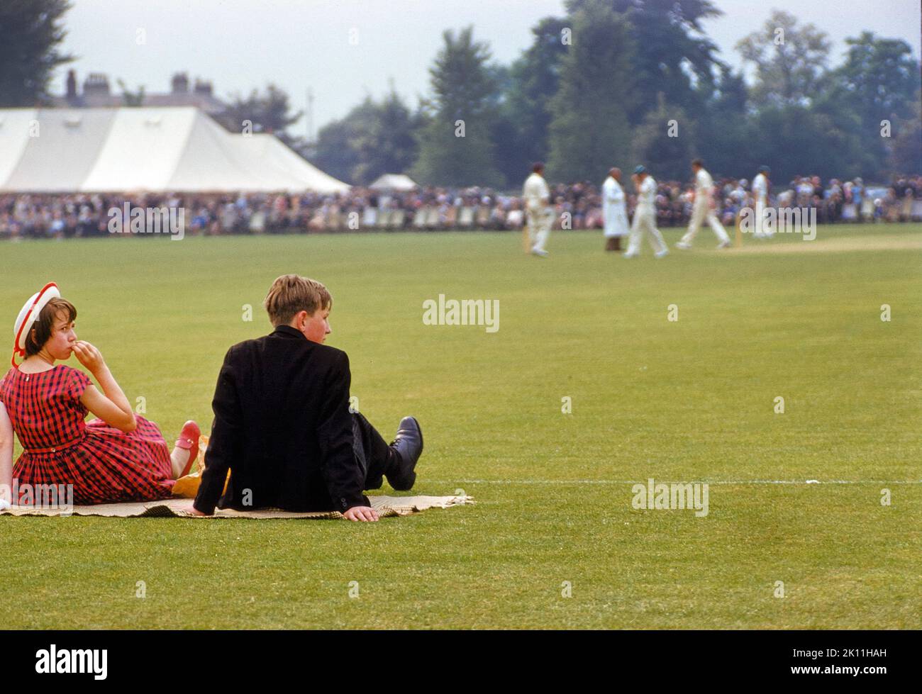 Teen Boy and Girl watching Cricket Match at 'Fourth of June' event, Eton College, Eton, Berkshire, England, UK, Toni Frissell Collection, June 4, 1959 Stock Photo