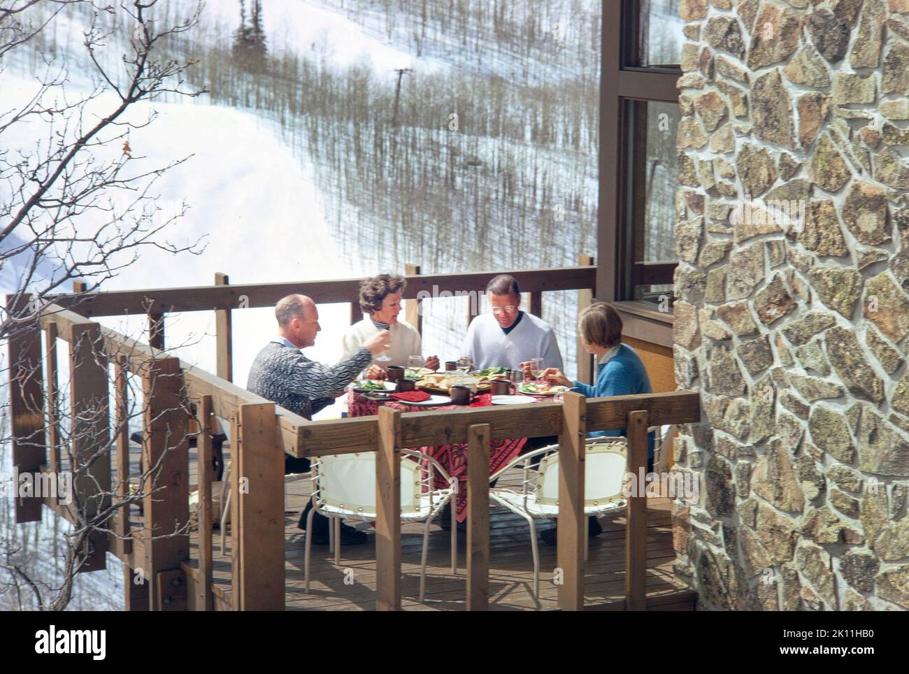 Former U.S. Secretary of Defense Robert McNamara with his wife Margaret and unidentified couple having lunch on Balcony, Snowmass Village, Colorado, USA, Toni Frissell Collection, February 1969 Stock Photo