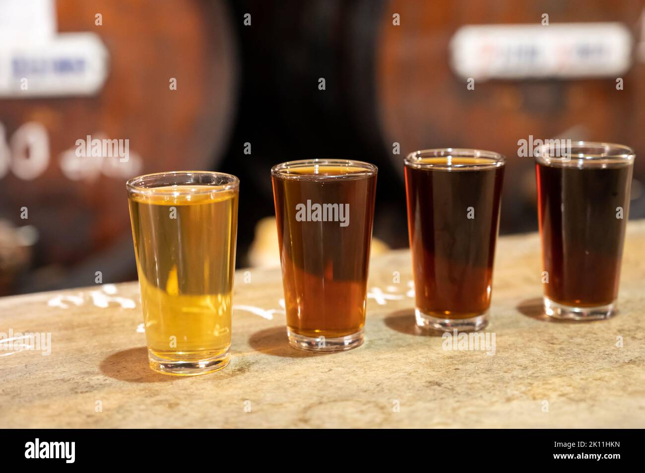 Tasting of different sweet wines from wooden barrels on old bodega wine