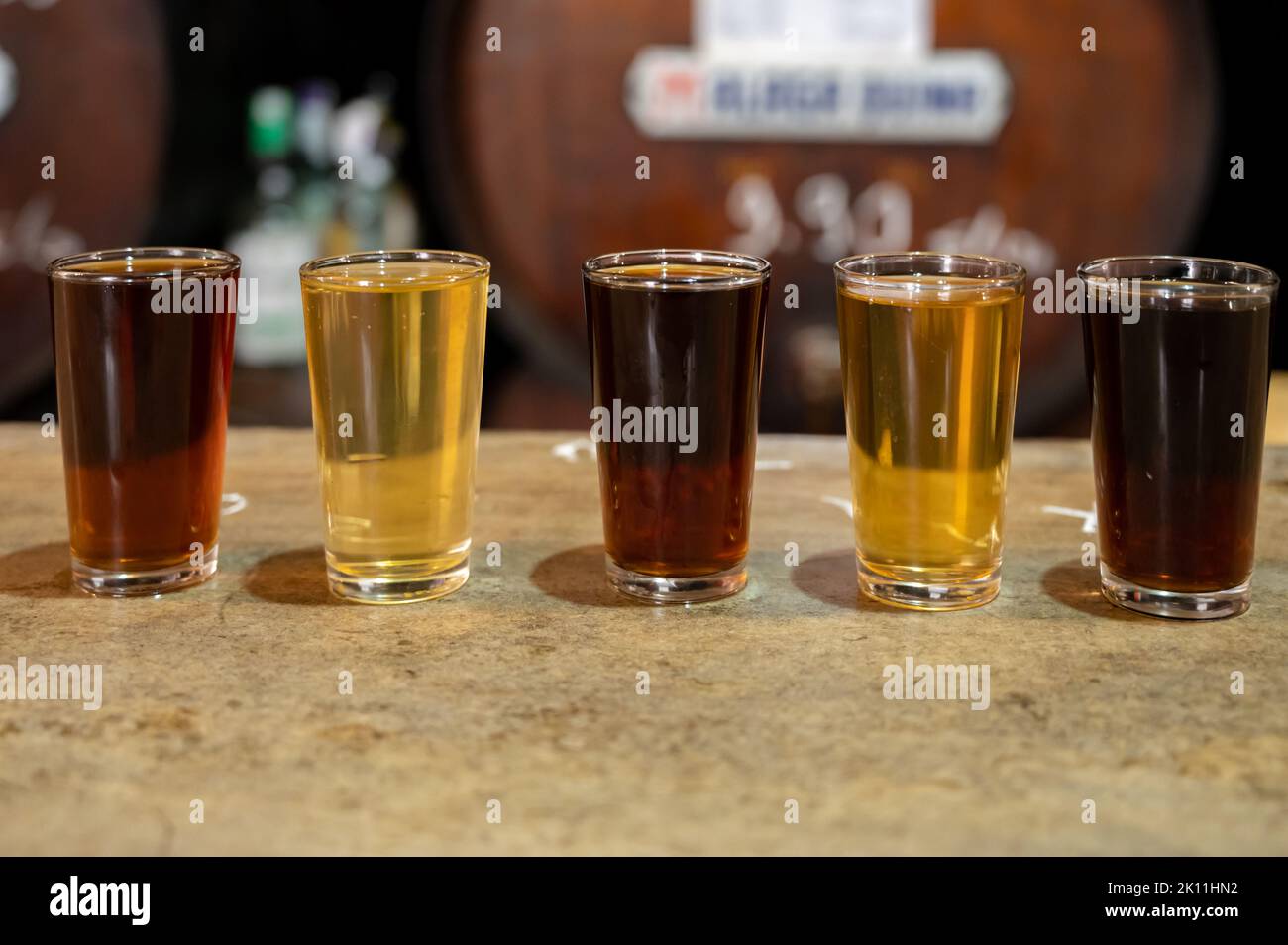 Tasting of different sweet wines from wooden barrels on old bodega wine