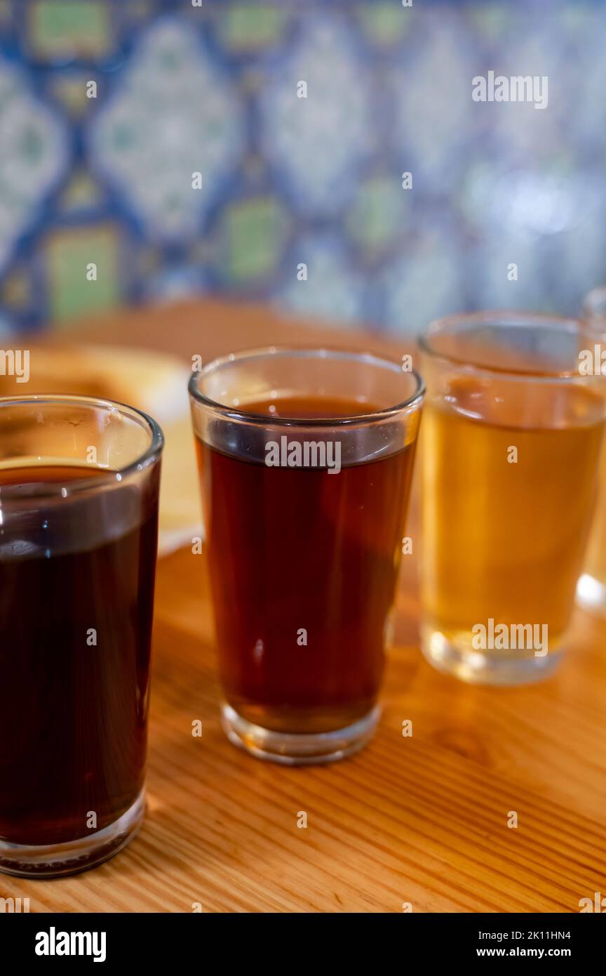 Tasting of different sweet wines from wooden barrels on old bodega wine