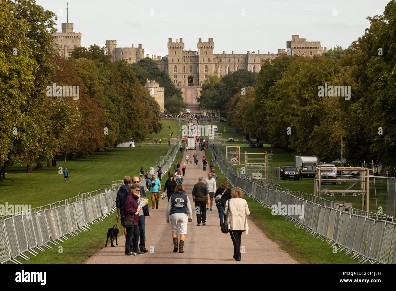 Windsor, UK. 14th September, 2022. Mourners proceed along the Long Walk in Windsor Great Park to lay floral tributes to Queen Elizabeth II outside Windsor Castle. Queen Elizabeth II, the UK's longest-serving monarch, died at Balmoral aged 96 on 8th September after a reign lasting 70 years and will be buried in the King George VI memorial chapel in Windsor following a state funeral in Westminster Abbey on 19th September. Credit: Mark Kerrison/Alamy Live News Stock Photo