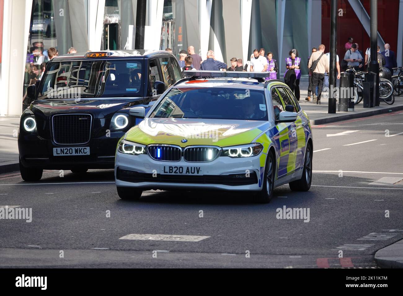 London, UK. 14th September 2022. On the death of Queen Elizabeth II - a police car with lights flashing in Westminster on the day the Queen's coffin is taken in a procession from Buckingham Palace to Westminster Hall for the lying-in-state, followed by her children and grandchildren, including King Charles III. Credit: Andrew Stehrenberger / Alamy Live News Stock Photo