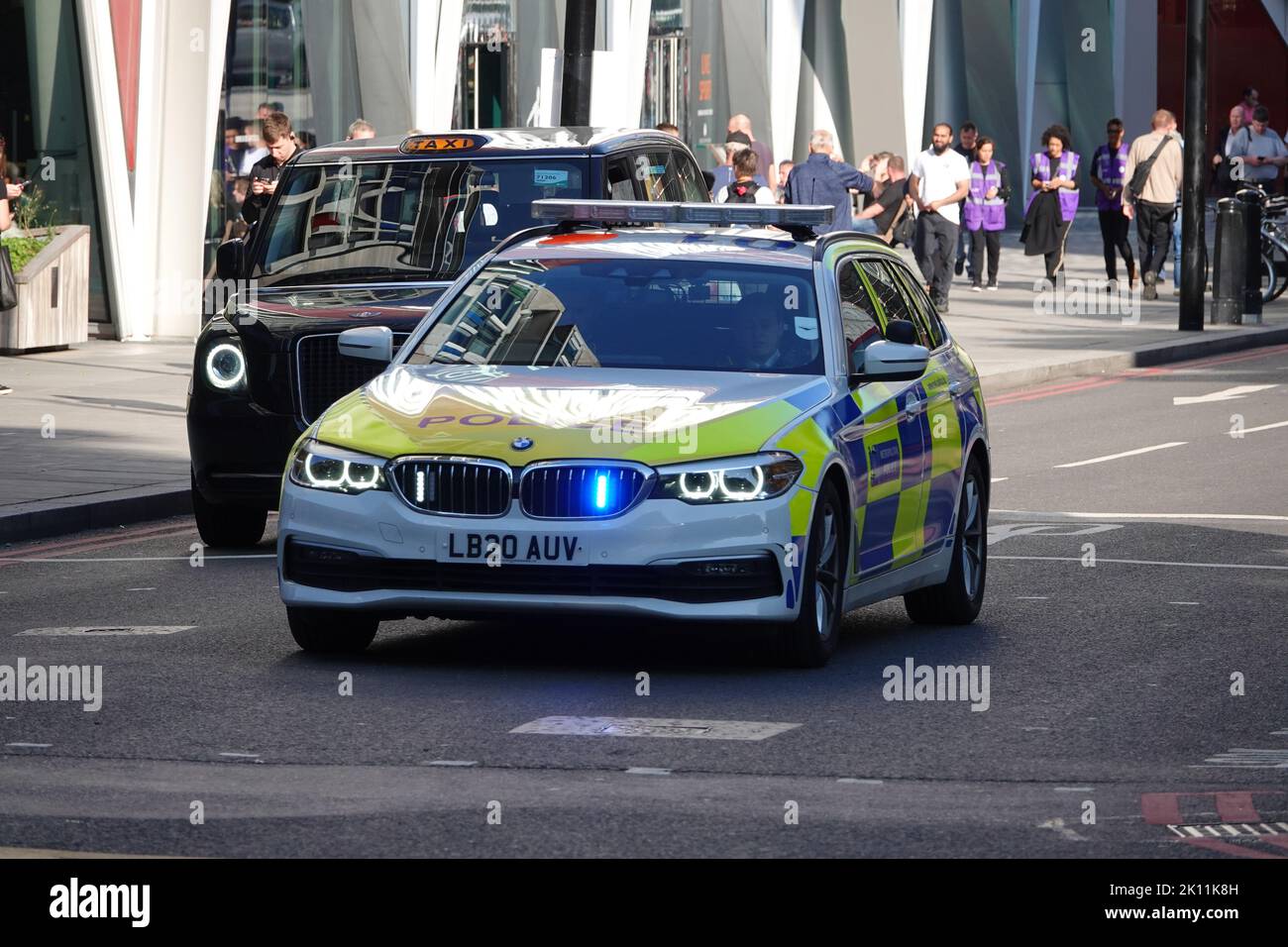 London, UK. 14th September 2022. On the death of Queen Elizabeth II - a police car with lights flashing in Westminster on the day the Queen's coffin is taken in a procession from Buckingham Palace to Westminster Hall for the lying-in-state, followed by her children and grandchildren, including King Charles III. Credit: Andrew Stehrenberger / Alamy Live News Stock Photo