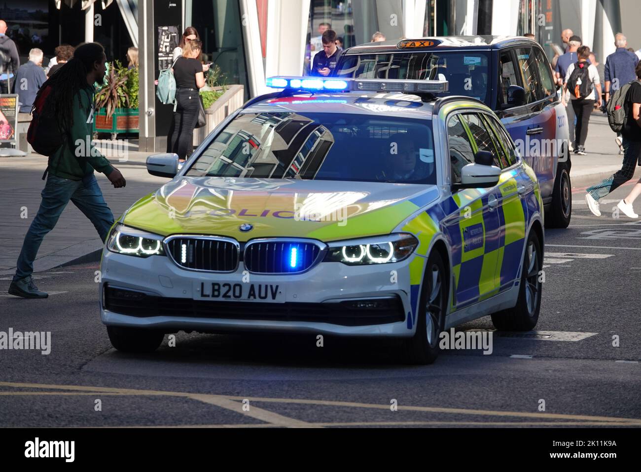 London, UK. 14th September 2022. On the death of Queen Elizabeth II - a police car with lights flashing in Westminster on the day the Queen's coffin is taken in a procession from Buckingham Palace to Westminster Hall for the lying-in-state, followed by her children and grandchildren, including King Charles III. Credit: Andrew Stehrenberger / Alamy Live News Stock Photo