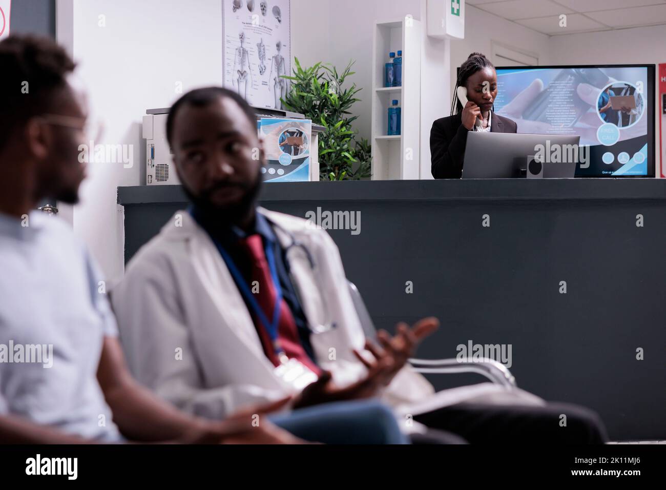 Hospital worker using landline phone call to make appointments with