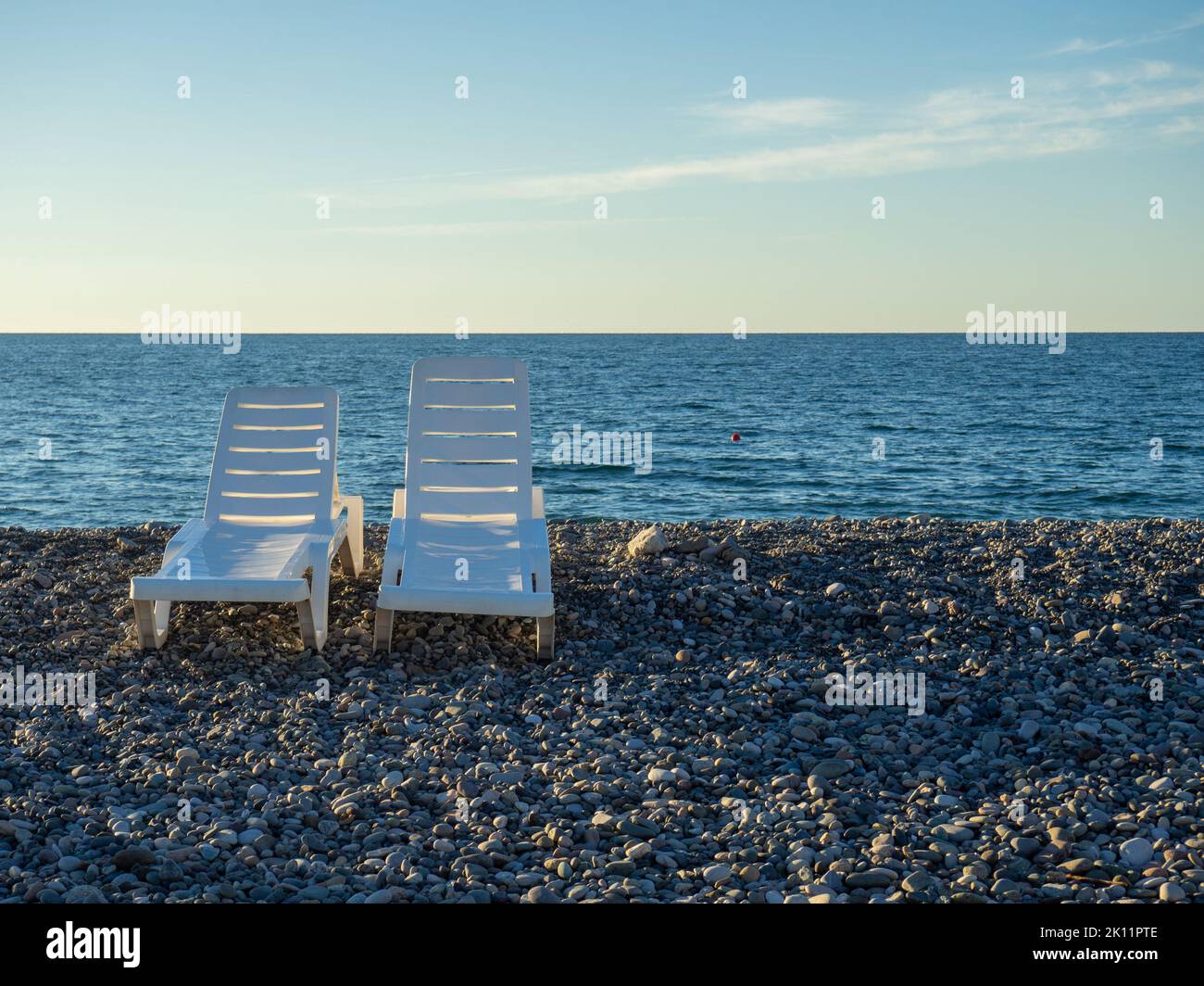 Beach beds. Folded beds. End of the season. On the Sunset. Beach vacation. Resort by the sea