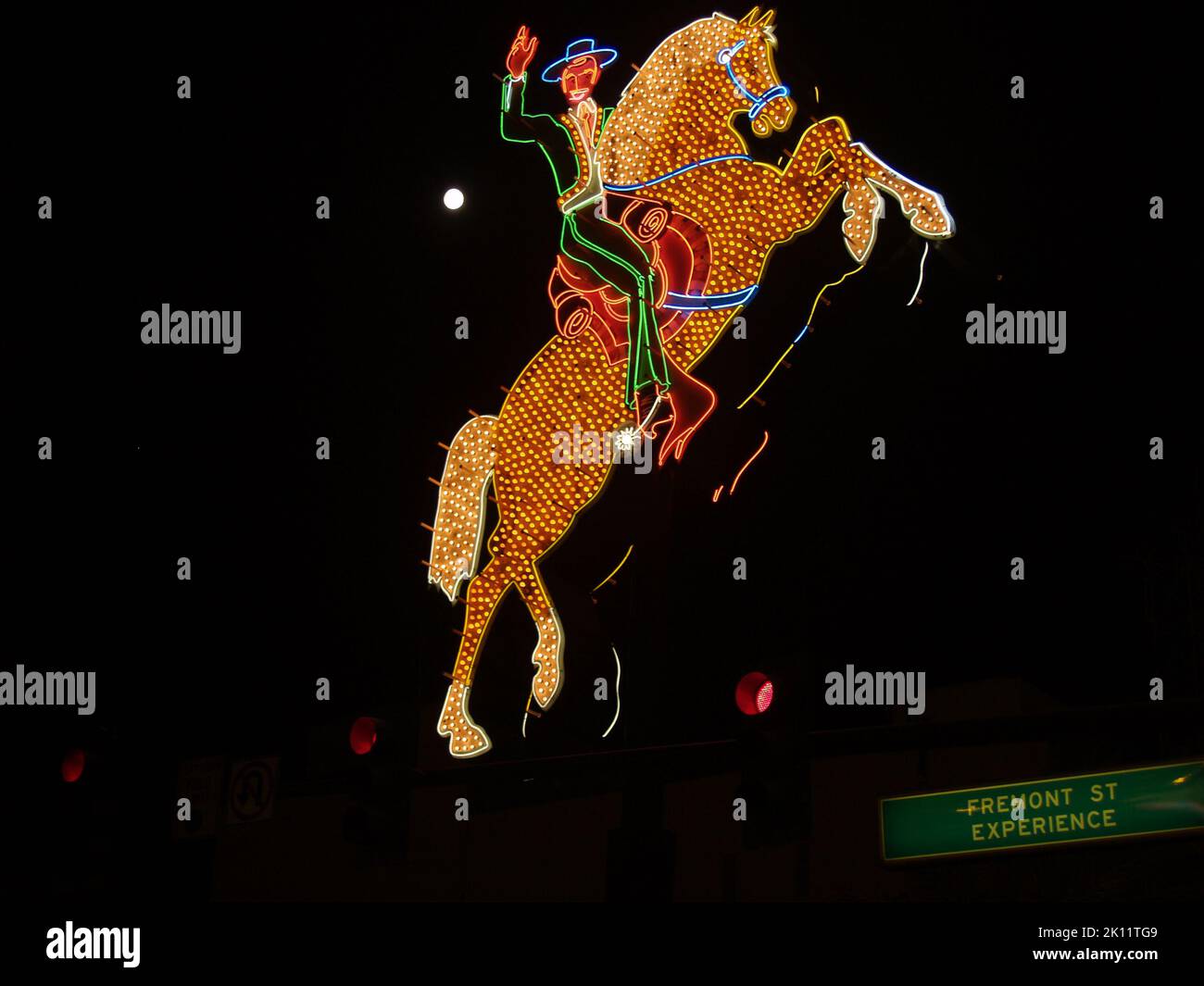 Las Vegas USA - August 15 2008; Old Hacienda neon horse and rider over Fremont Street Experience road sign Stock Photo