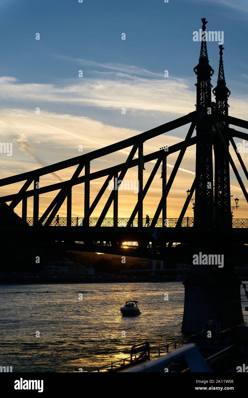 The historic Freedom Bridge over the Danube River, Szabadsag hid, in Budapest at sunset Stock Photo
