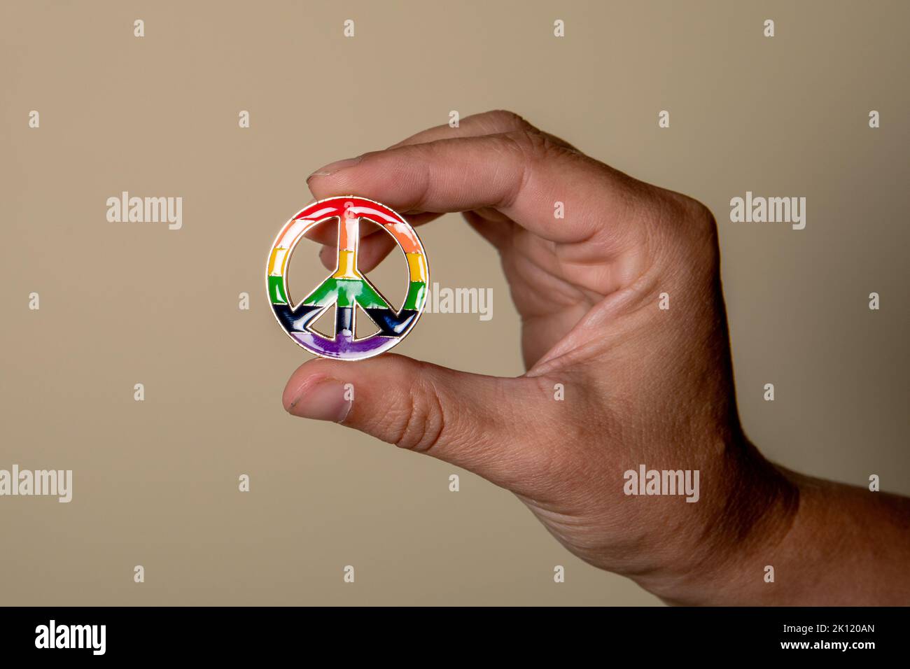 Peace sign in hand, rainbow colors. Love and equality concept. Stock Photo